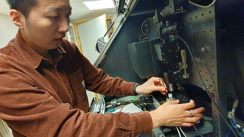 Lee-Lun Lai demonstrates the setup to print silica glass. Image credit: KTH.